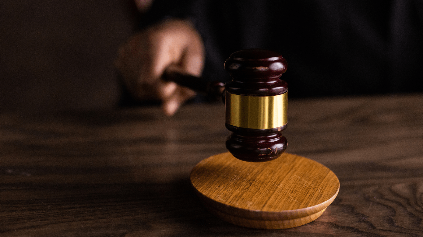 a person in a suit and tie is holding a gavel