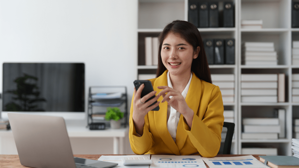 a person smiling on front of mobile phone