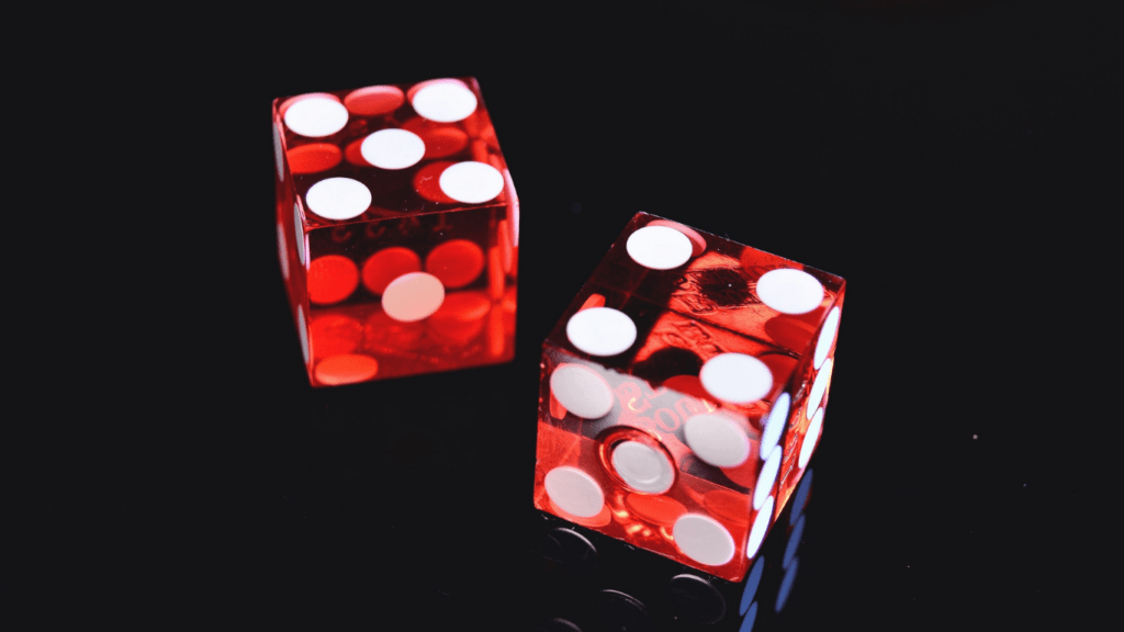 two red dices against black background