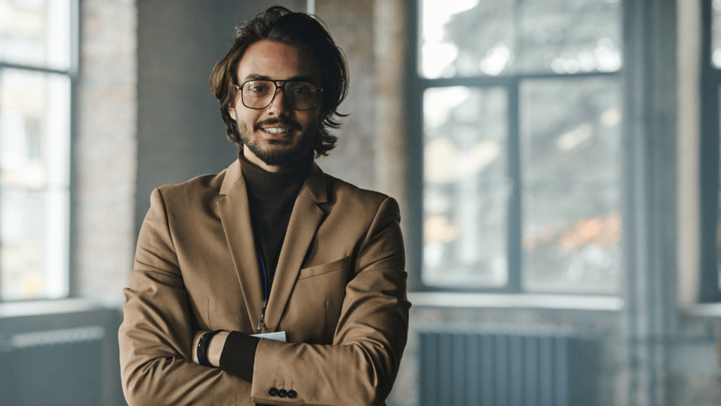 smiling man wearing brown suit