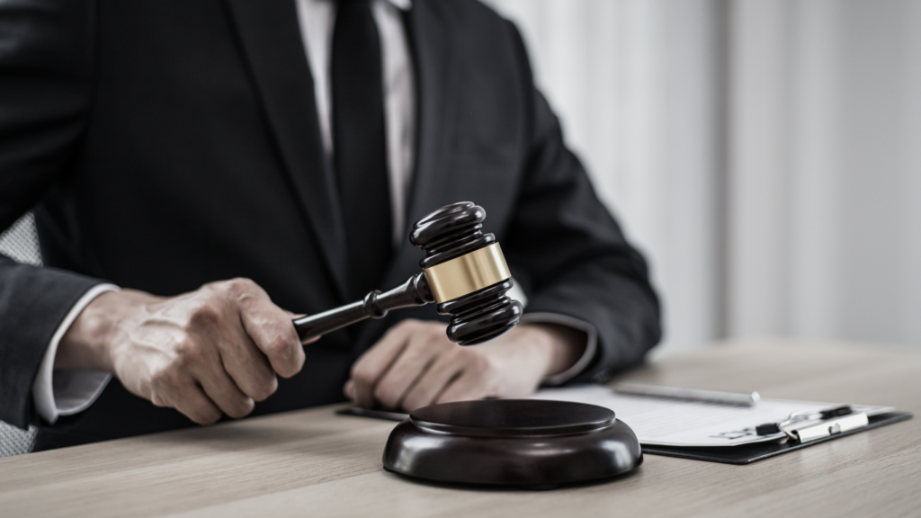 a person in a suit and tie is holding a gavel