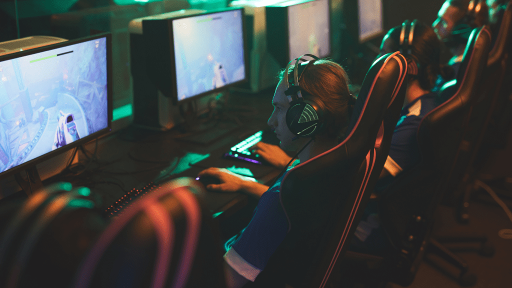 a person sitting at a desk in front of a computer screen